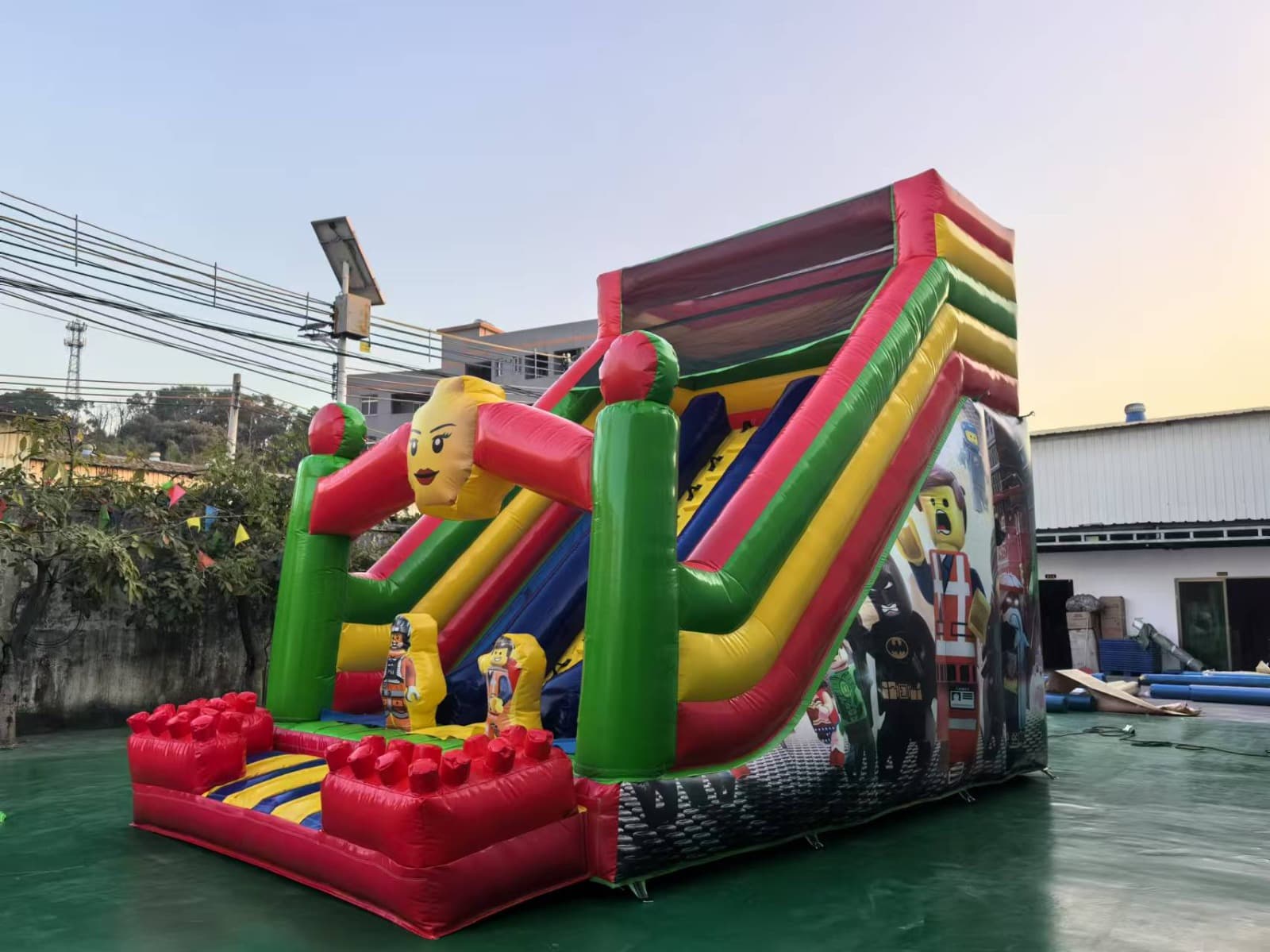 Large block hero themed inflatable dry slide.