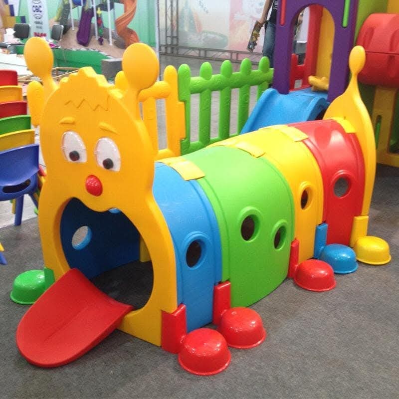 Colourful caterpillar crawl tunnel for an indoor soft play area.
