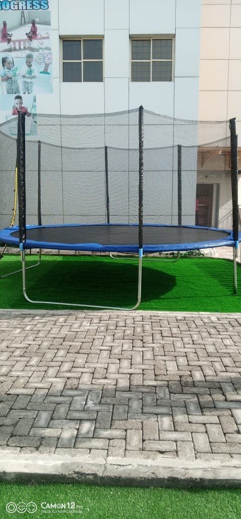 Enclosed safety net trampoline installed at a school play area by Ere Ayo Mothercare Toys.