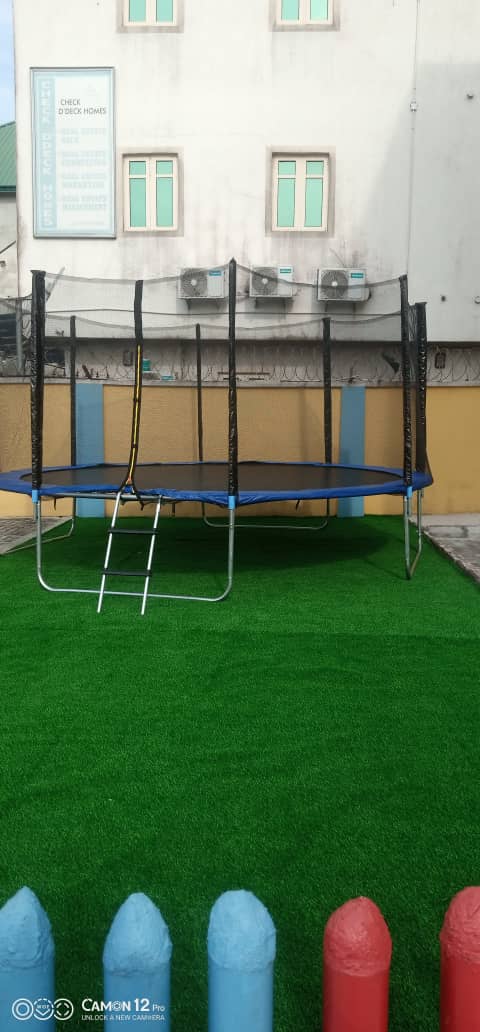 Enclosed trampoline installed on the grounds of a hotel by Ere Ayo Mothercare Toys.