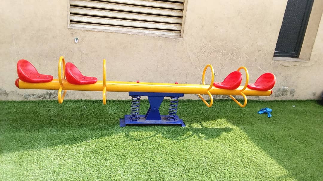 Four seat sprung metal seesaw suited to school and creche play areas.