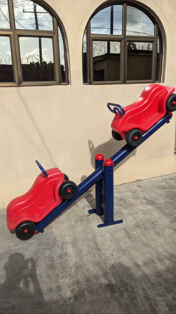 Two seat ride on car seesaw installed on a home patio by Ere Ayo Mothercare Toys.