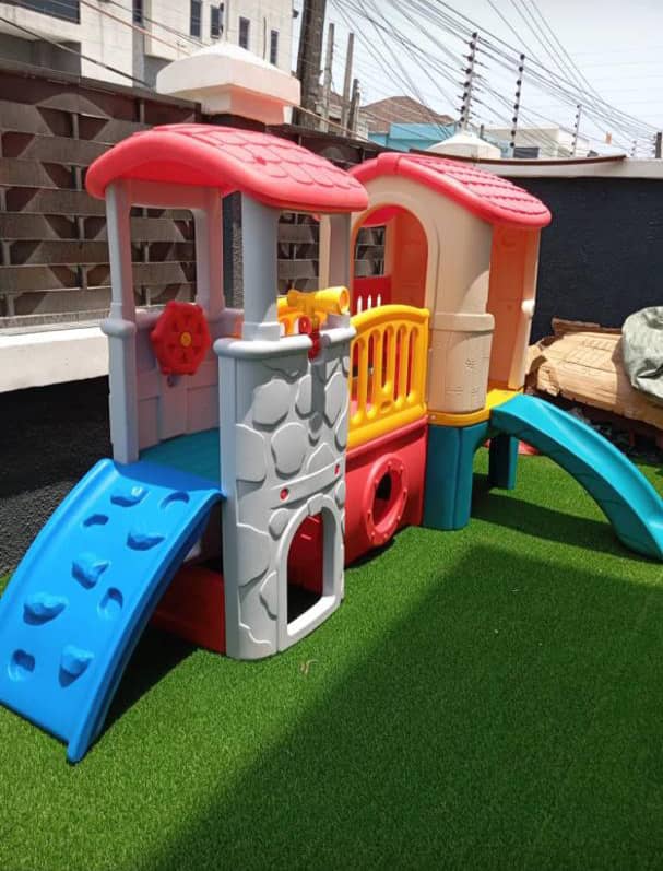 Train themed multiplay house with climbing wall and slide installed on a rooftop play terrace by Ere Ayo Mothercare Toys.